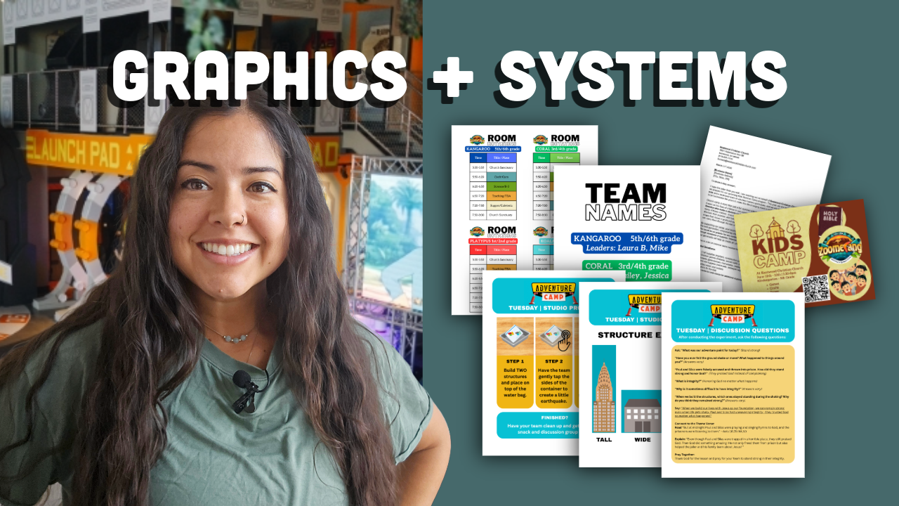 Woman standing in a classroom with educational materials and graphics displayed on screens behind her.